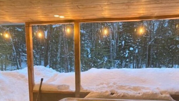 A wooden cabin with a hot tub.