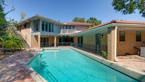 A two-story house with a swimming pool, a balcony, and a brick exterior. - Poolside Oasis Near Medical Center & NRG Stadium! (Houston)