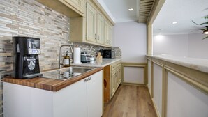 A kitchen with a coffee maker, microwave, and sink. - Poolside Oasis Near Medical Center & NRG Stadium! (Houston)