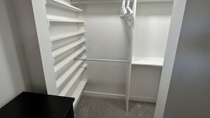 A walk-in closet with white shelving and hanging space. - Heart of Richfield, ATVs & Mountain Biking, Spacious Home, Sporting Events (Richfield)