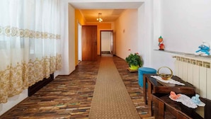 A hallway with patterned flooring, a wooden ceiling, and a radiator on the wall. - Holiday home with internet access and air conditioning (Grižane)