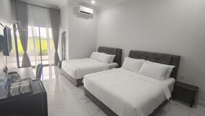 A hotel room with two beds, a desk with a chair, and a window with curtains. - Paddy Villea Inn (Bukit Mertajam)