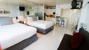 A modern hotel room with two beds, a sofa, a dining area, and a kitchen. - Castle 1120 Cozy Studio with Intercoastal View, Free Parking, Tennis, Pool, Gym, Beach Access (Miami Beach)