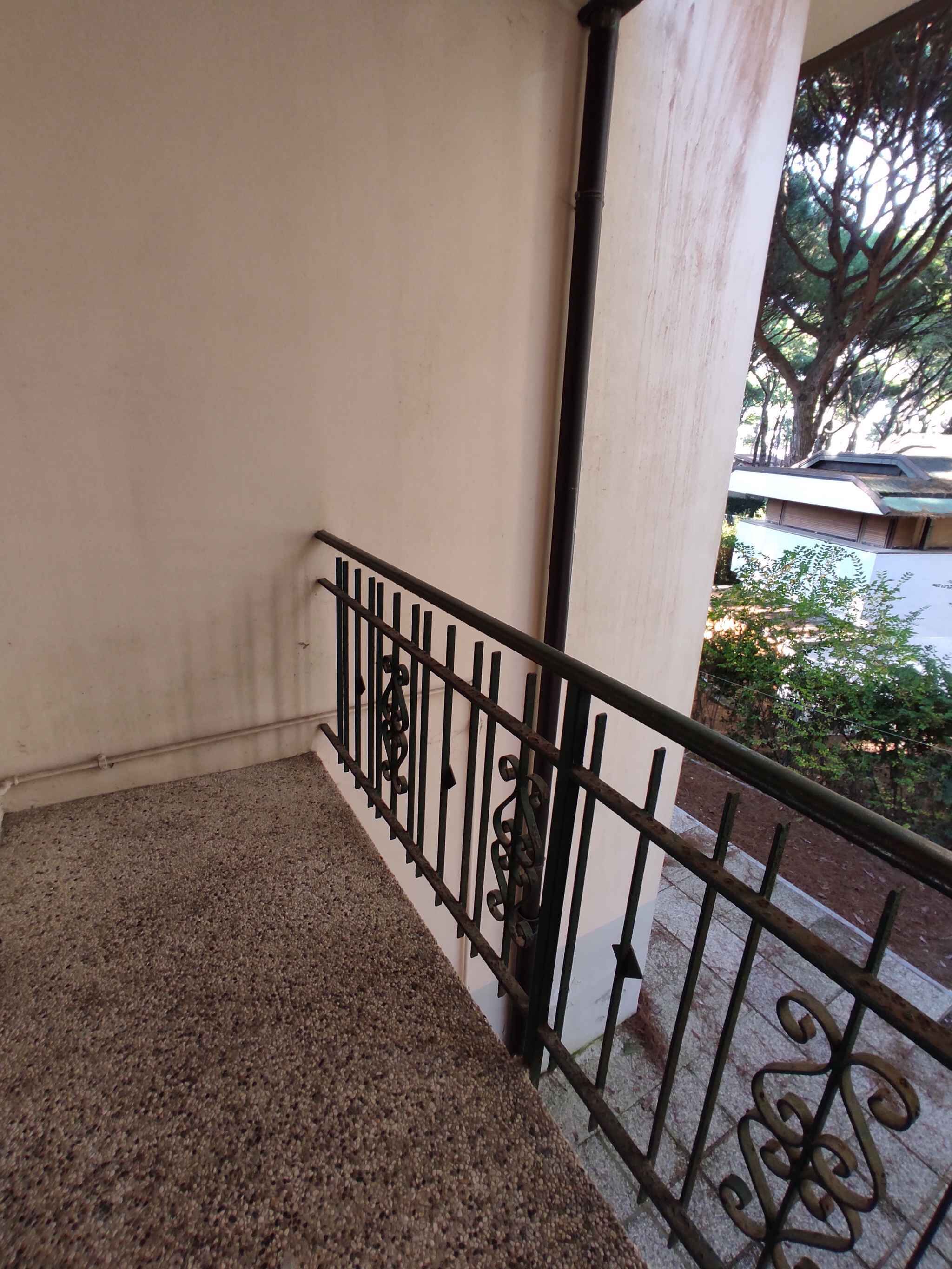 A staircase with a metal railing leading to an outdoor area.