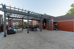Relax in the shaded patio area with a sofa and dining table.