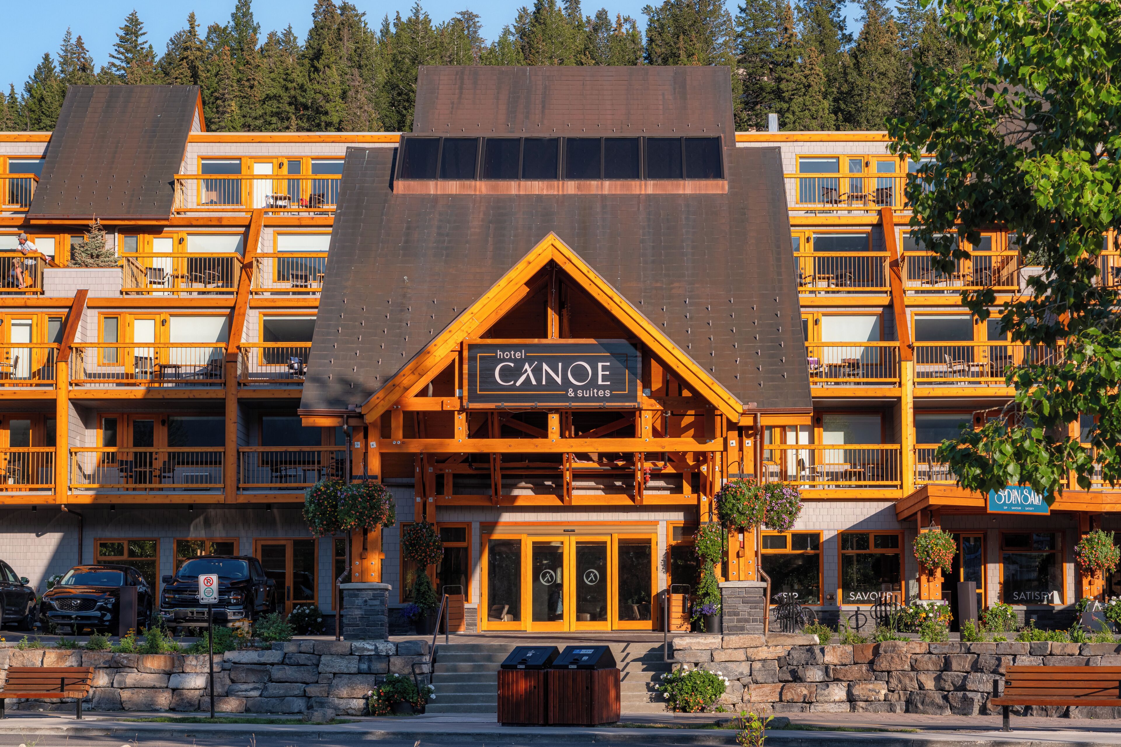 A multi-story hotel with a prominent sign reading 'Canoe & Suites.'