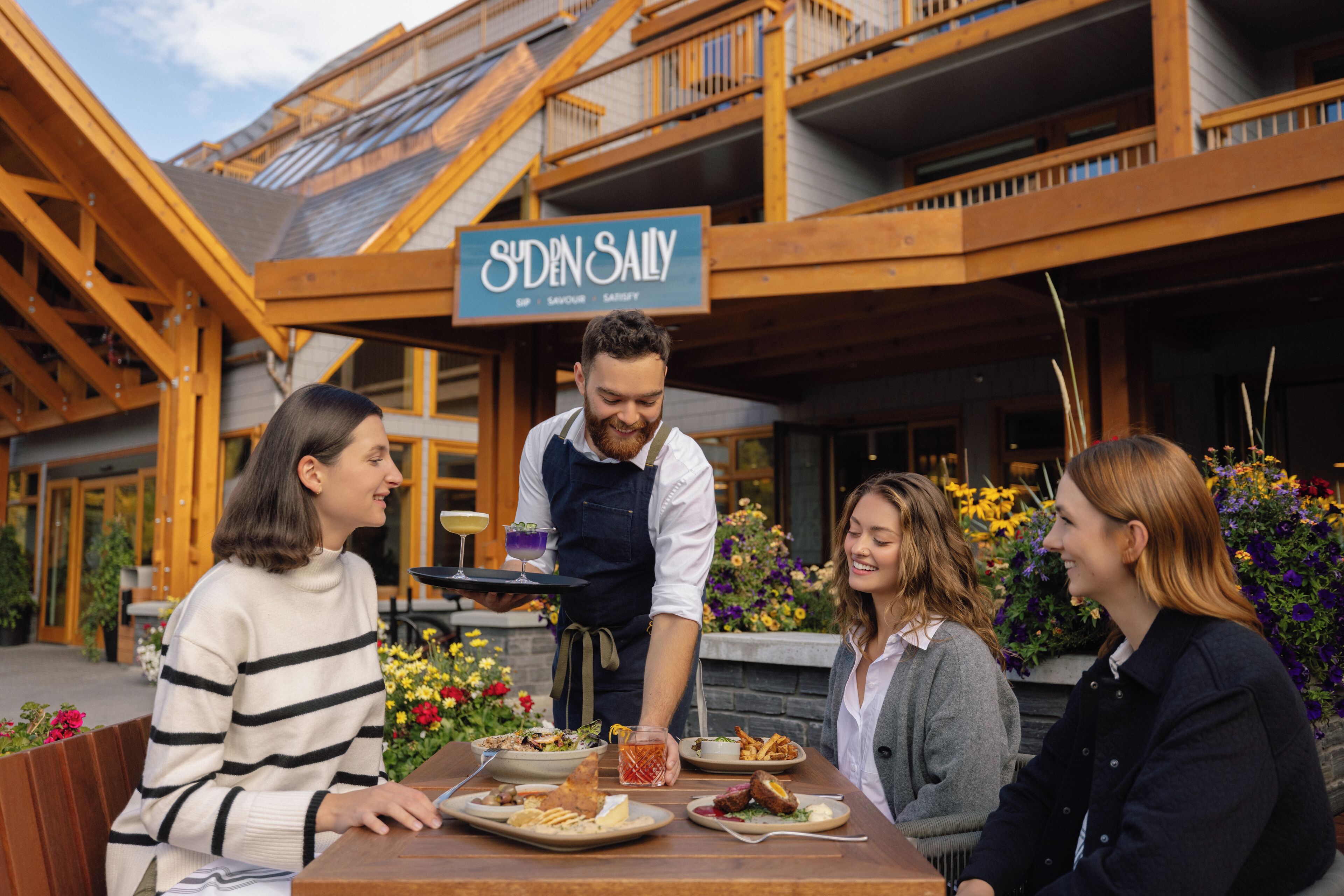 A restaurant with a wooden exterior and a sign reading "Sudden Sally".