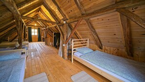 A wooden attic room with bunk beds and a sloped ceiling. - Amazing home in Dragovanscak (Dragovanscak)