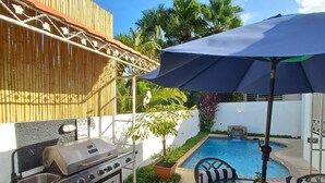 A patio with a grill, outdoor table, chairs, and a pool. - San Juan, 2 rooms w/private pool, outdoor kitchen/BBQ & nearby & peaceful (San Juan)