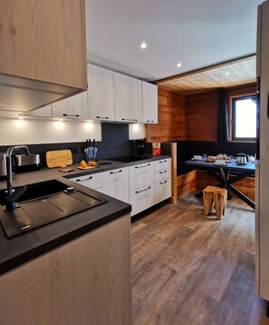 Enjoy cooking in this well-equipped kitchen with a sink, stove, and ample storage space.