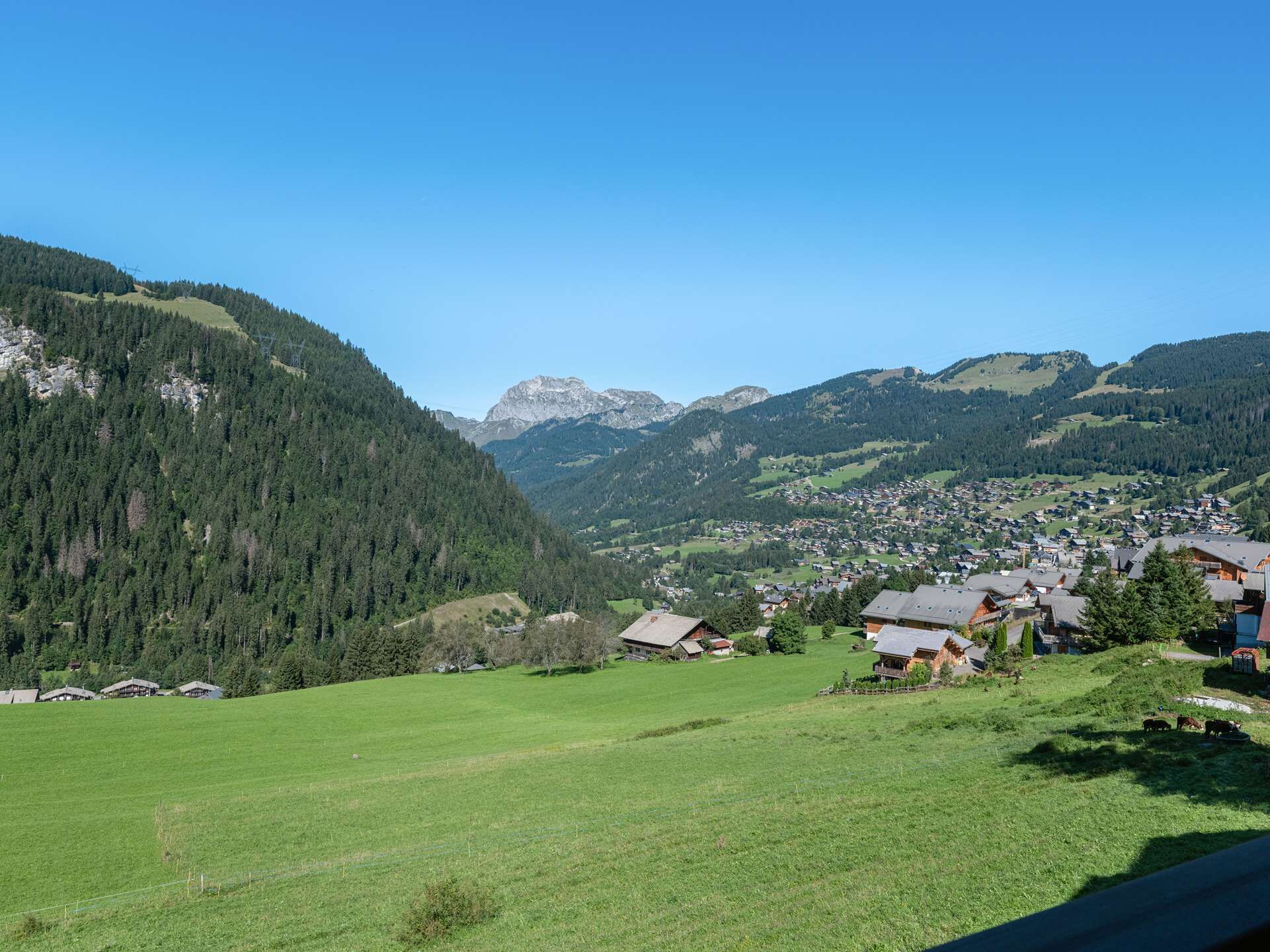 A mountainous landscape with a village nestled in the valley.