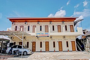A two-story building with a sign advertising "Home Stay / KOST A3 Executive".