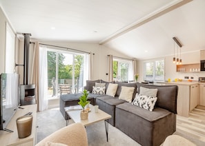 A modern living room with a sofa, coffee table, and a TV.