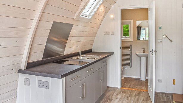 A compact kitchen with a skylight, a built-in sink, and a view into the adjacent bathroom. - 0 bedroom accommodation in King&rsquo;s Lynn (King&rsquo;s Lynn)