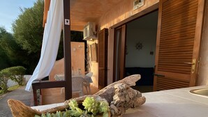 A wooden log planter with succulents on a patio. - Holiday Home "Casa OriMar 419" with Shared Pool and Wi-Fi (Badesi)