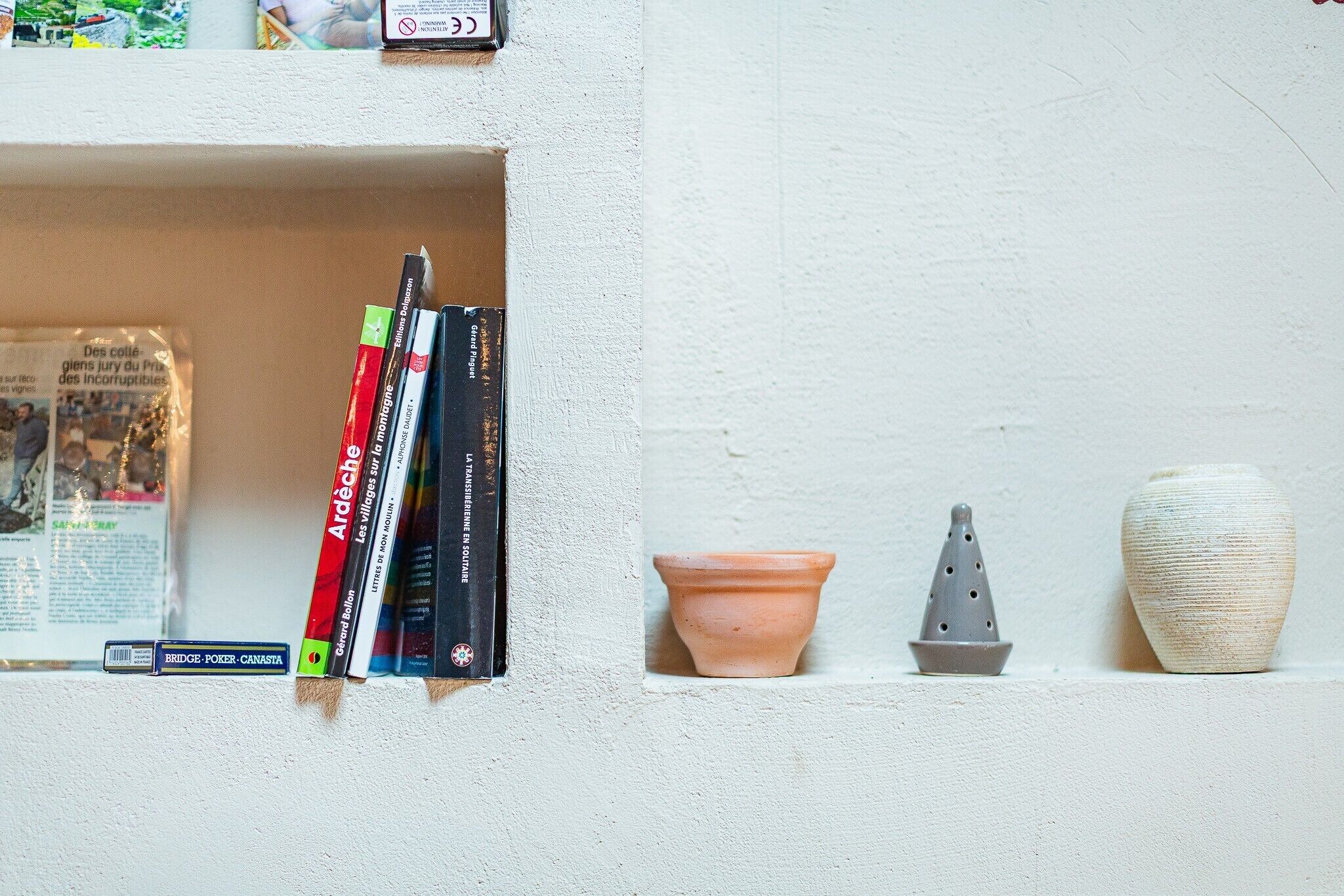 A shelf with books and decorative items.