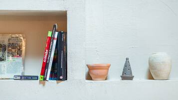 A shelf with books and decorative items.