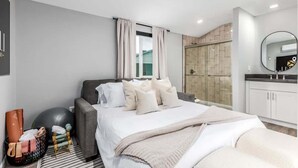 A modern bedroom with a bed, exercise ball, and yoga mat. - The Monterey | Pool, Sport Court & Putting Green (Scottsdale)