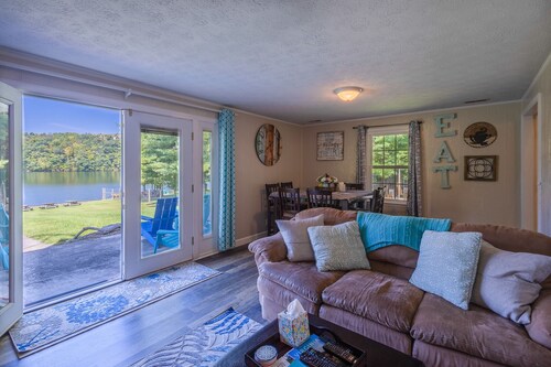 Charming lakefront retreat with cozy interiors, private dock, fire pit, and breathtaking water view