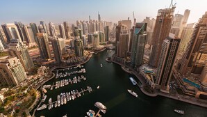 A high-rise urban area with a marina filled with boats.