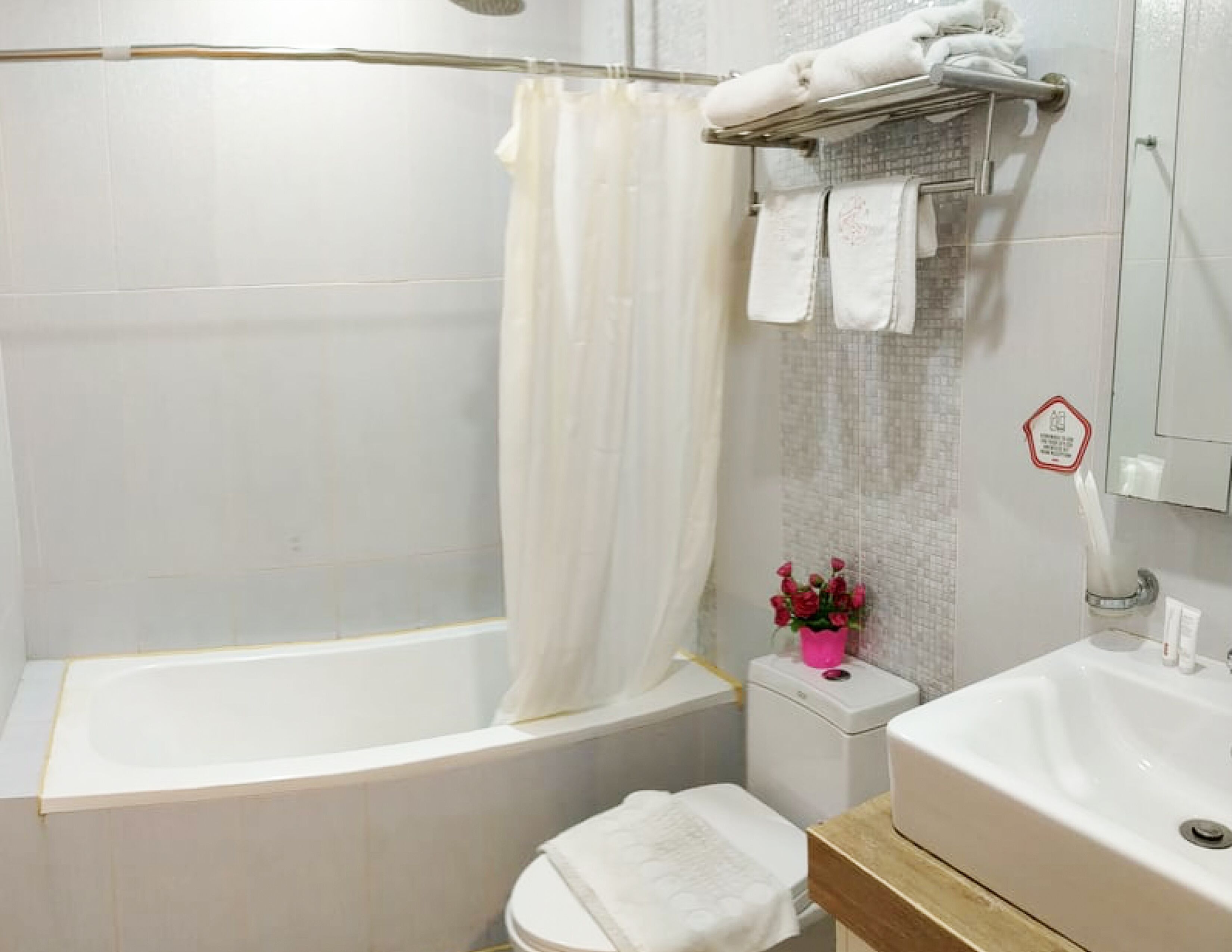 A bathroom with a bathtub, toilet, and sink.