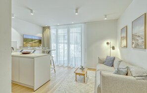 A modern living room with a sofa, a coffee table, and a TV. - 1 bedroom awesome apartment in Tossens (Tossens)
