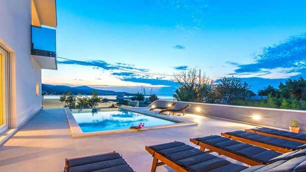 A rooftop pool area with lounge chairs and a view of the sea and mountains. - Stunning home in Zadar, Pasman (Zadar, Pasman)