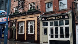 A brick building with a sign for "The Lower Turks Head" and "Joseph Holt". - Lower Turks Head  (Manchester)