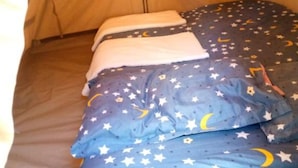 A tent with a bed inside, featuring a star and moon pattern on the bedding. - Sofa Camp Naivasha (Naivasha)