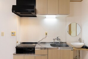 Family Apartment | Private kitchen | Full-size fridge, microwave, stovetop, electric kettle - Tatekawa 333 Residence (Tokyo)
