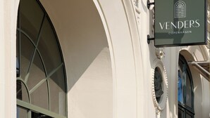 A building facade with a sign reading "VENDERS Copenhagen" and a number "11" above an arched window.