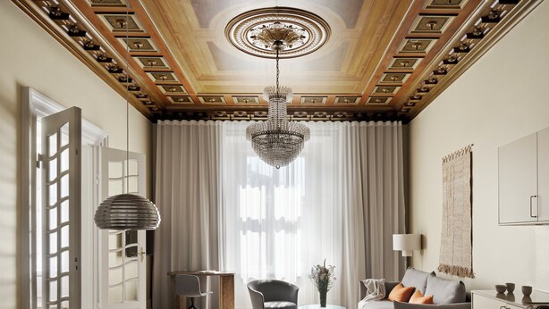A modern living room with a dining area, a chandelier, and a view of the outdoors through large windows.