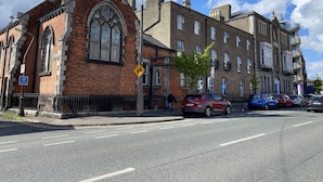 A historic building with a large arched window and a clock.