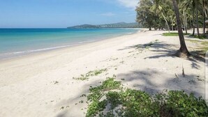 A beach with white sand, palm trees, and clear blue water. - Perfect 2br Pool Villa In Residence Bangtao Beach4 (Tambon Choeng Thale)