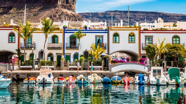 A coastal town with colorful buildings, a marina with boats, and a mountain in the background. - Playa Azul , Luxury Penthouse with spectacular roof terrace (Lomo Quiebre)