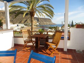 Enjoy a tranquil moment on this outdoor terrace overlooking the stunning coastal landscape.