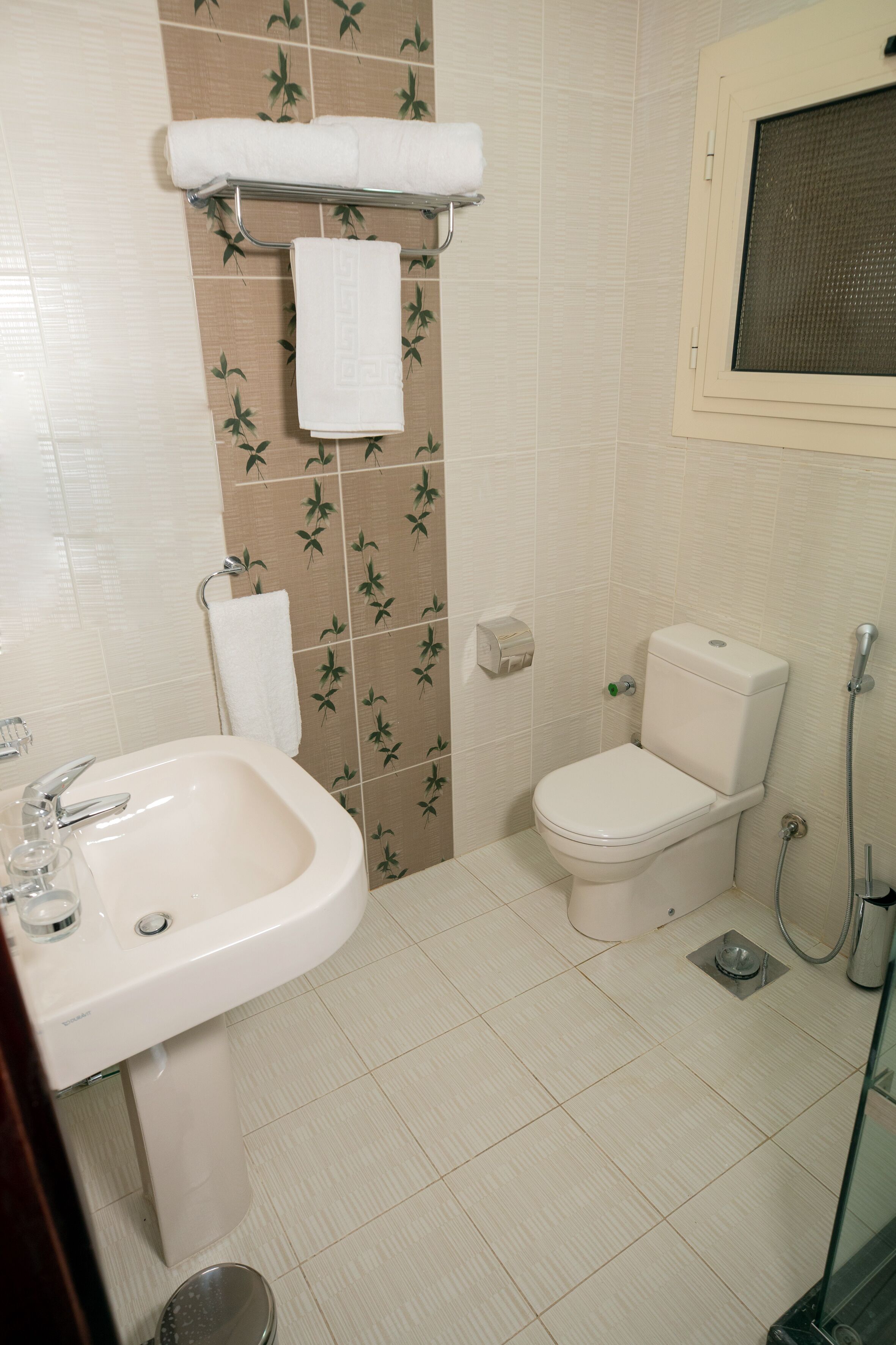 rainfall showerhead, hair dryer, slippers, towels