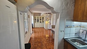 A kitchen with a tiled backsplash, a sink, and a refrigerator. - Duplex • Walk to Anfi Beach • 3 Pools • Large Terrace (Los Caideros)