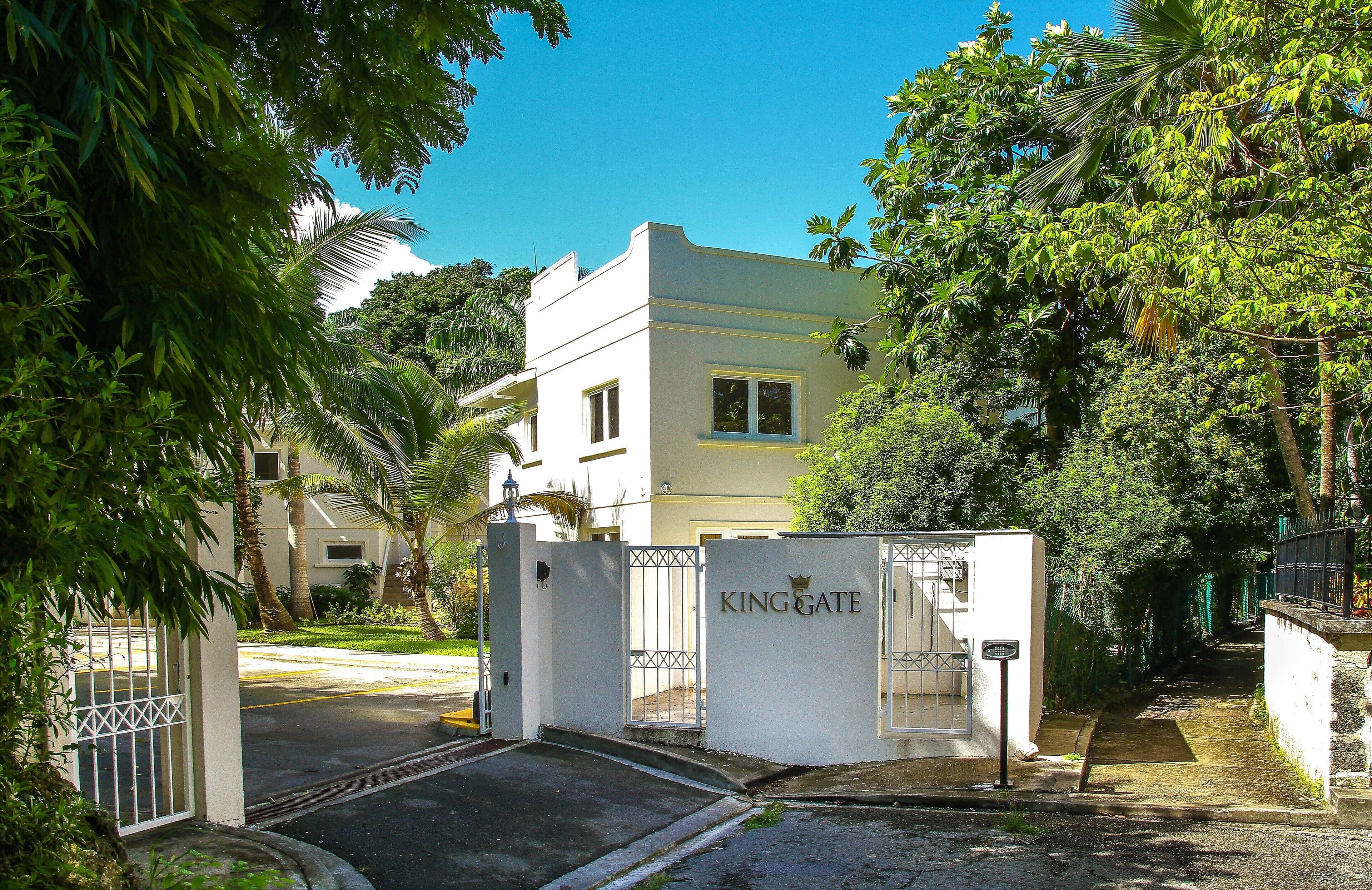 A gated entrance to a building with a sign reading "KING GATE".