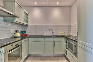 Fridge, microwave, oven, stovetop - Two Bedroom Apartment - fully furnished and design in V&a Marina Residential (Cape Town)