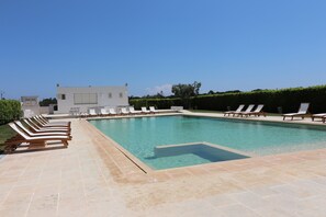A rectangular swimming pool with a tiled deck, surrounded by lounge chairs. - Montepulciano house in Torre Santo Stefano in Otranto 4 places (Otranto)
