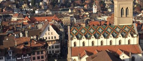 A historic building with a prominent tower and a courtyard.