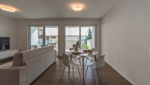 A modern kitchen with a dining area, large windows, and a view of the outdoors. - Vacation Rental City 10 in Massagno (Massagno)