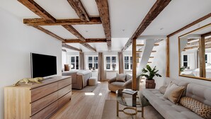 A modern living room with exposed wooden beams, a large flat-screen TV, a sofa, a coffee table, and a potted plant. - Regent 6- Cozy 1-Bdr Apt with Terrace in the Centre of Copenhagen (København)