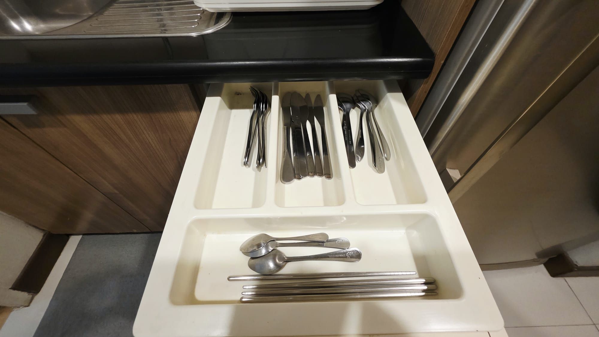 A kitchen drawer with utensils neatly organized.