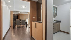 A modern kitchen with wooden cabinets and a countertop. - 3A - Short-Term Rental Allowed - Downtown Bkk Serviced Apartment (Krung Thep Maha Nakhon)