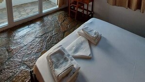A room with a bed, a desk, a chair, and large windows with curtains. - Apartment with Pool and Panorama View (Koumeika)