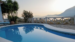 A swimming pool with a white fence and a view of mountains in the background. - Apartment with Pool and Panorama View (Koumeika)