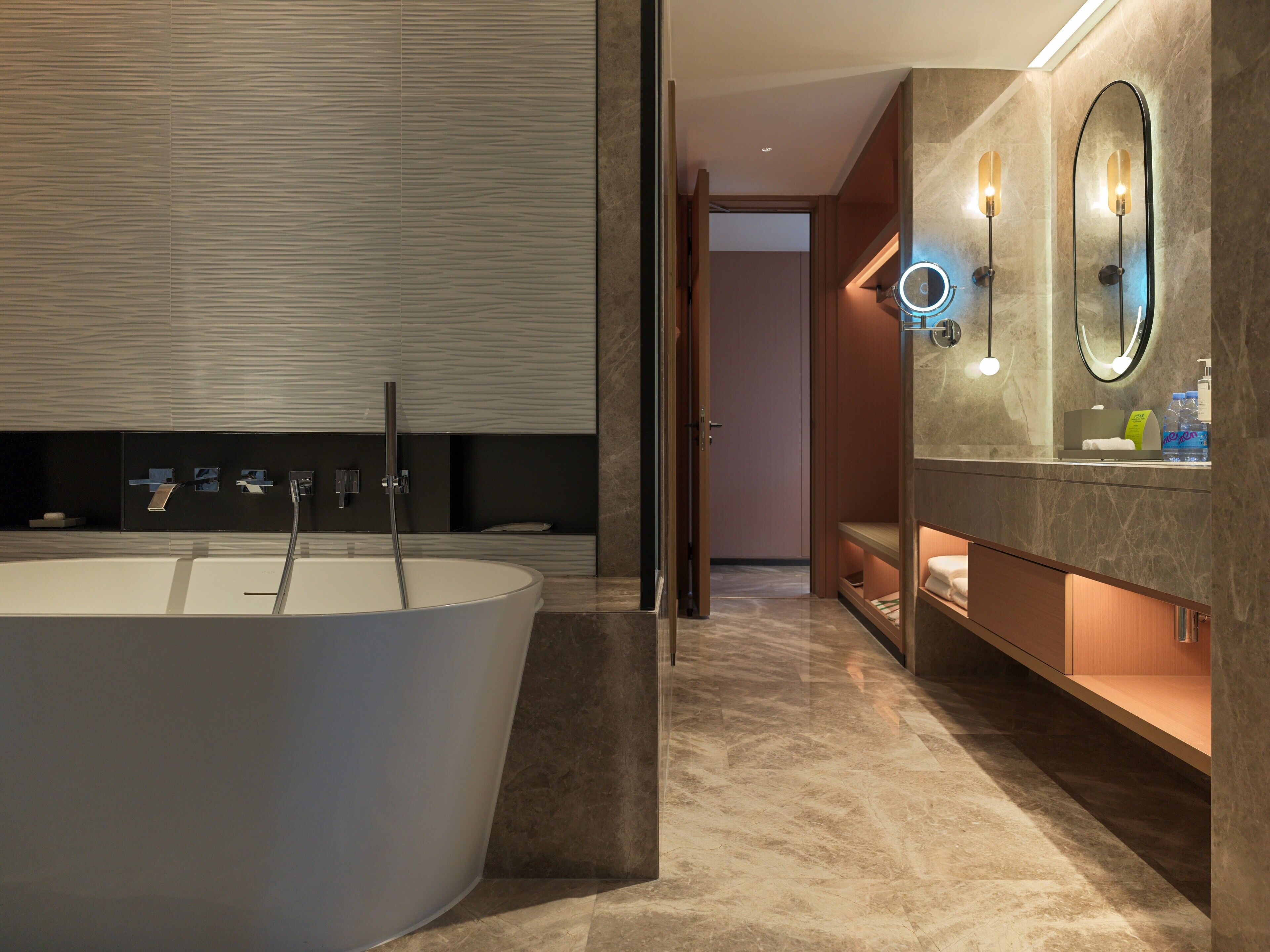 A modern bathroom with a freestanding bathtub, a vanity with a mirror, and a shower area.