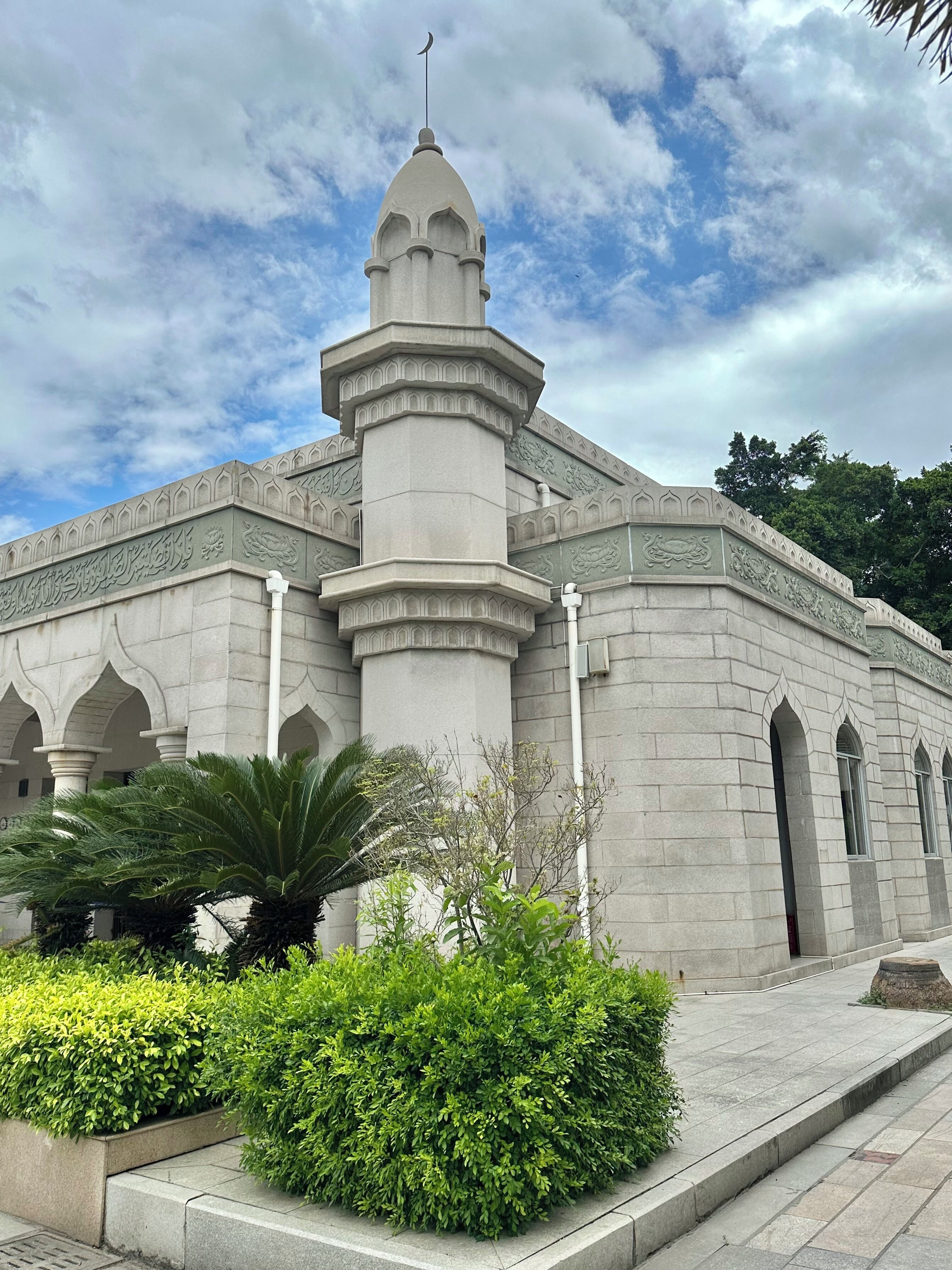 A mosque with a central dome, minarets, and arched windows.